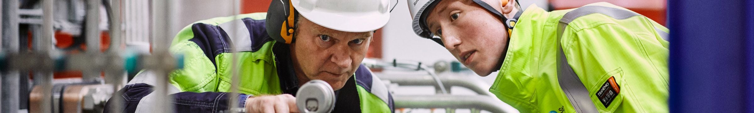 Employees looking at equipment at Ringendalen power plant in Norway